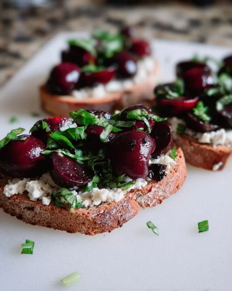 Delicious Black Cherry Basil Ricotta Toast topped with fresh herbs and cherries
