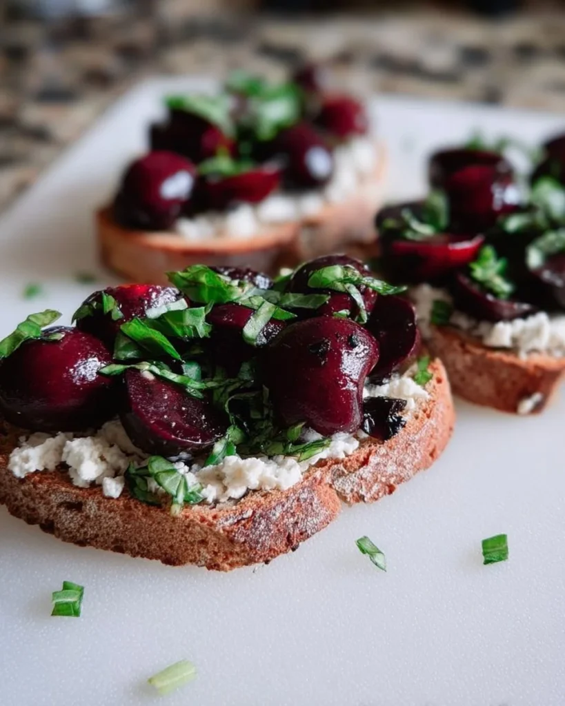 Delicious Black Cherry Basil Ricotta Toast topped with fresh herbs and cherries