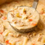 Bowl of easy creamy chicken noodle soup with egg noodles and vegetables