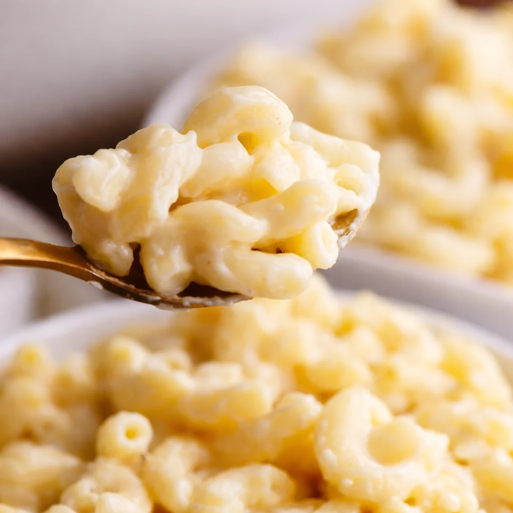 Creamy white sauce macaroni pasta topped with cheese and vegetables, quick recipe.